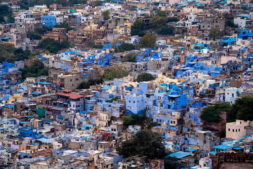 aerial drone shot showing jodhpur blue city cityscape showing traditional houses in middle of aravalli with colorful densely packed houses © Memories Over Mocha