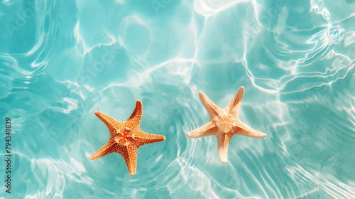 Abstract background blue water surface on the water two starfish