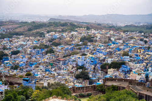 aerial drone shot showing jodhpur blue city cityscape showing traditional houses in middle of aravalli with colorful densely packed houses