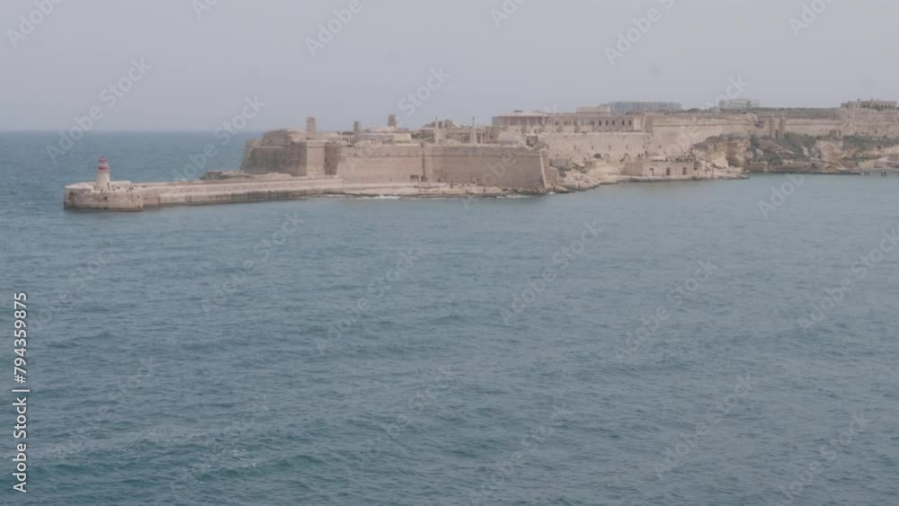 A shot of the lighthouse at Fort Ricasoli on a windy day. From Valletta, Malta.