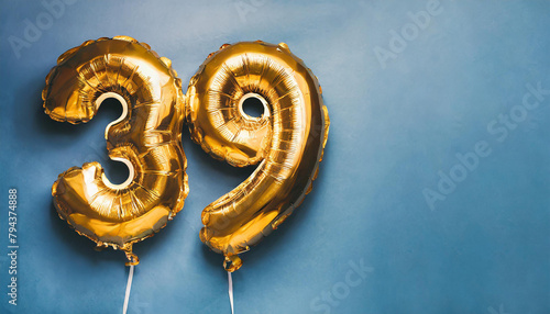 Banner with number 39 golden balloon. Thirty nine years anniversary celebration. Blue background. photo