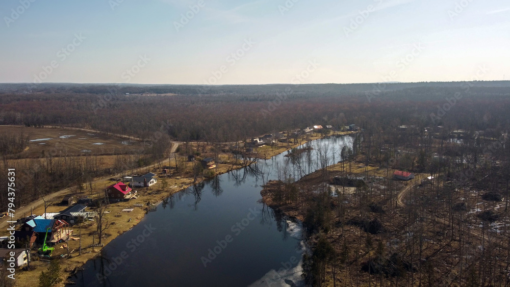 Am aerial view of a lake and cottages. 