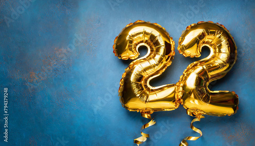 Banner with number 22 golden balloon. Twenty two years anniversary celebration. Blue background.