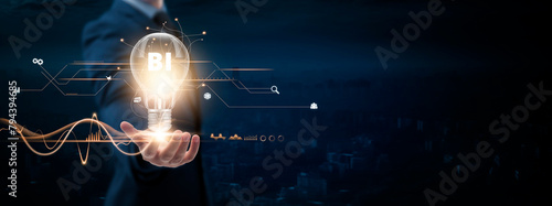 BI: Businessman holding creative light bulb with Digital networking and Business Intelligence (BI) icon. Data Analytics, Decision-making, Insights, on blue city background. photo