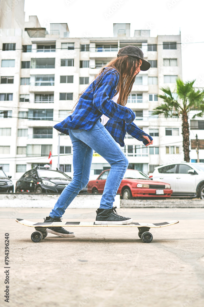 Girl having fun riding skateboards at skate park, Portrait of smiling young female skateboarder holding her skateboard. Recreational Activity Concept.