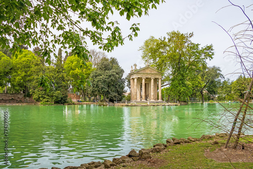 Lake in the gardens of villa Borghese with the temple of Asclepius in the background