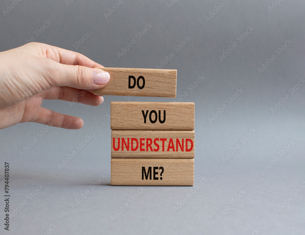 Do you understand me symbol. Concept words Do you understand me on wooden blocks. Beautiful grey background. Businessman hand. Business and Do you understand me concept. Copy space. Do you understand me symbol. Concept words Do you understand me on wooden blocks. Beautiful grey background. Businessman hand. Business and Do you understand me concept. Copy space.