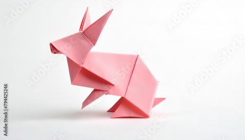 Animal concept origami isolated on white background of a pink bunny rabbit with pointy ears straight up sitting facing sideways away from camera with copy space