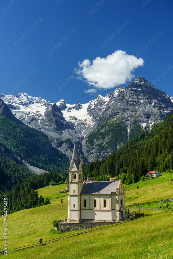Mountain landscape along the road to Stelvio pass at summer. Church