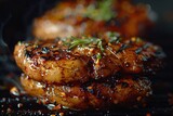 Grilled chicken thighs garnished with herbs, covered in sticky glaze, on a smoky grill.