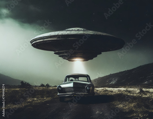 Unidentified flying object grabbing a car at dark environment condition