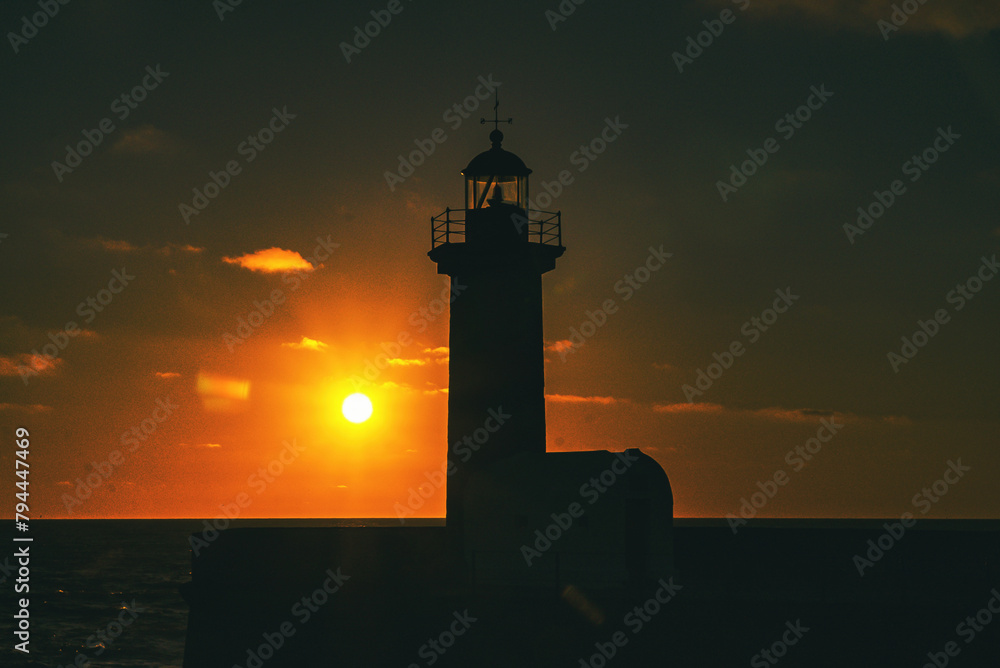 Felgueiras Lighthouse in silhouette with beautiful colorful sunset sky. Porto, Portugal. 