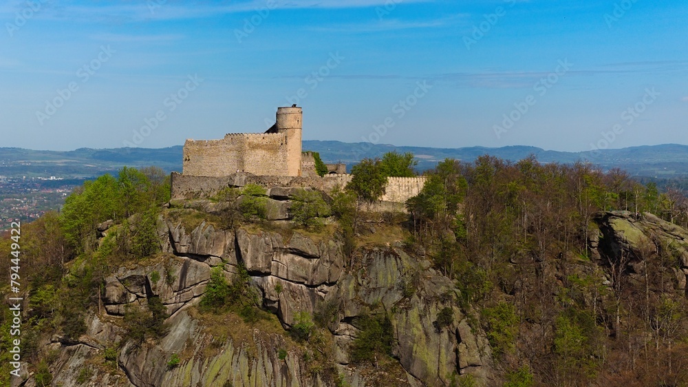 Medieval Chojnik Castle atop Karkonosze mountain in aerial shot.