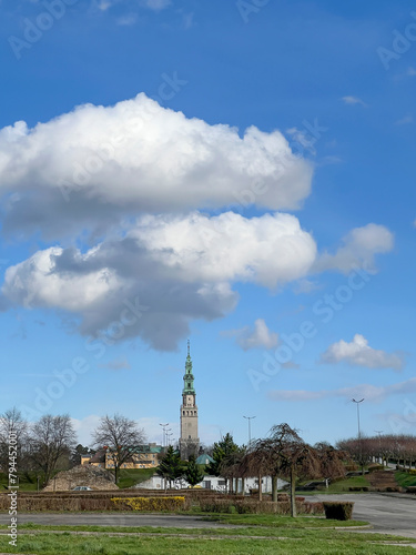 The tower of the Jasna Gora Monastery in Czestochowa, Poland, seen from a distance, from the west with clouds in the sky