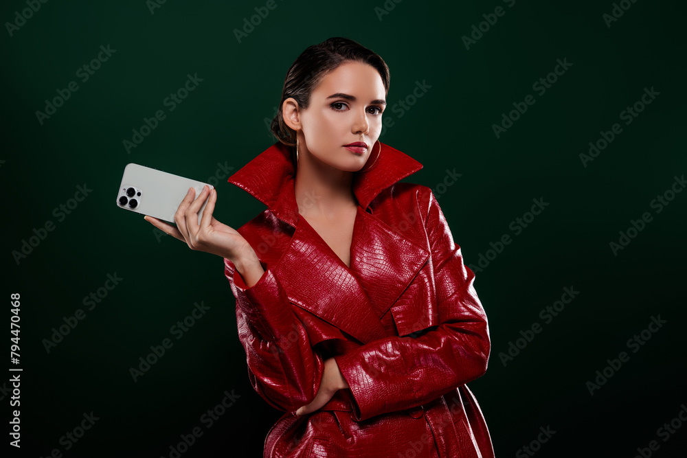 Naklejka premium Photo of attractive girl hold cell smart device look elegant wear coat isolated dark color background