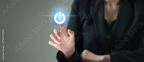 businesswoman pressing power button. Start or shut down concept.. Hand of businessman pressing power button over computer. photo