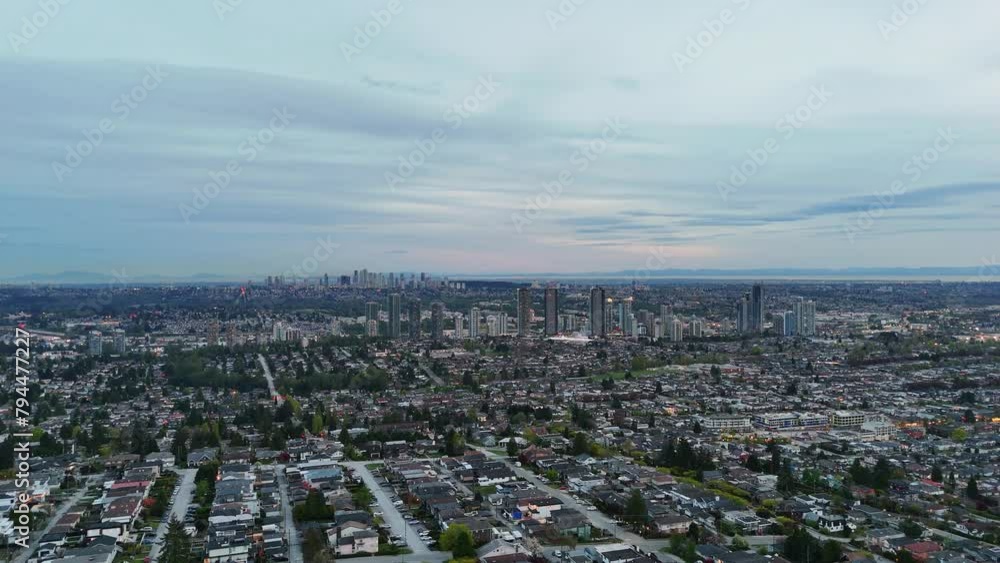Panoramic aerial drone view (pan right) of the evening skyline of Burnaby during a spring season in British Columbia, Canada Panoramic aerial drone view (pan right) of the evening skyline of Burnaby during a spring season in British Columbia, Canada