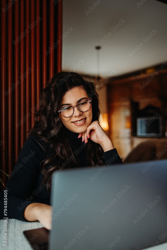 One young caucasian woman working on laptop from home One young caucasian woman working on laptop from home