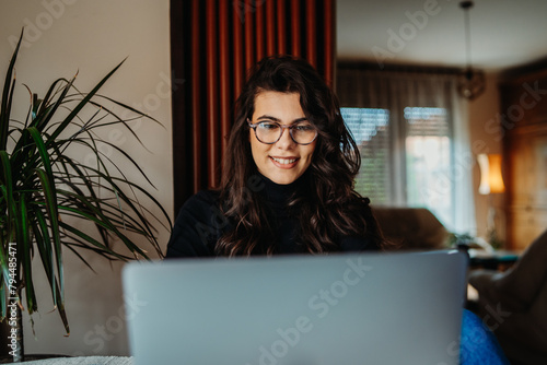 One young caucasian woman working on laptop from home