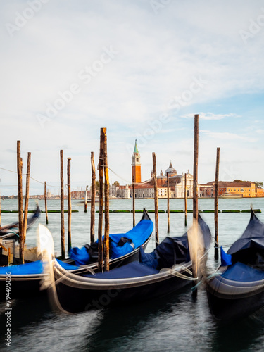 Gondolas moored by Saint Mark square with San Giorgio di Maggiore church in Venice, Italy