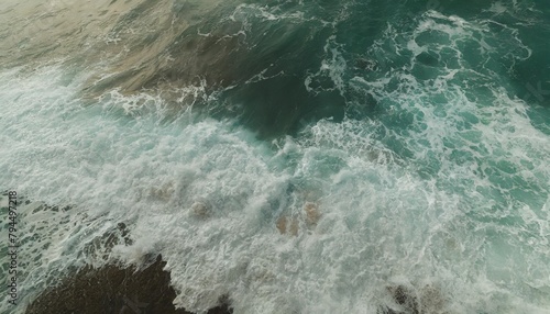 from above aerial view of turquoise ocean water with splashes and foam for abstract natural background and texture