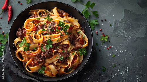 Pasta fettuccine with beef ragout sauce in black bowl, Grey background, Copy space, Top view