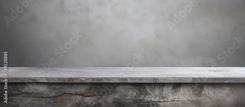 Monochrome photography of a concrete table with a grey wall in the background