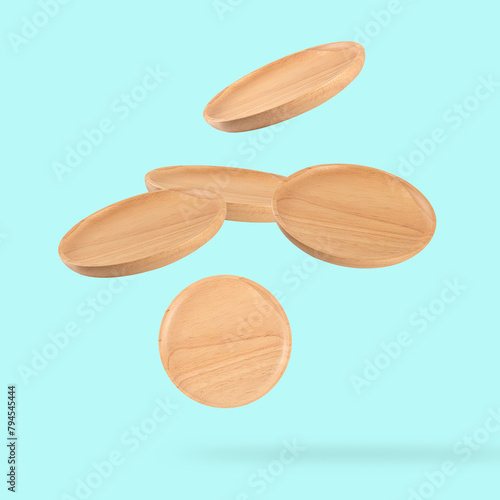 Falling wooden tray on cyan background.