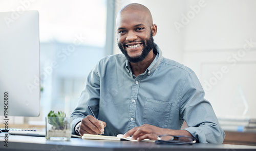 Businessman, desk and notebook in portrait with smile in office with planning for creative project. Accountant, auditor and keeping records with analyst in corporate with technology for treasurer