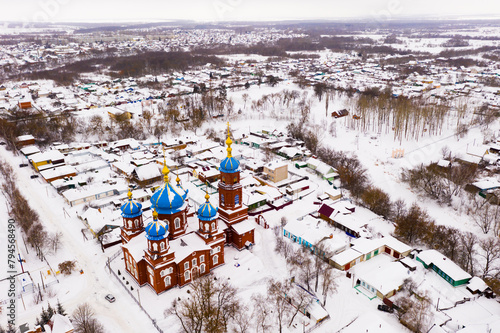 Winter drone view of residential areas and the Church of the Intercession of the Most Holy Theotokos in Petrovsk, Russia.