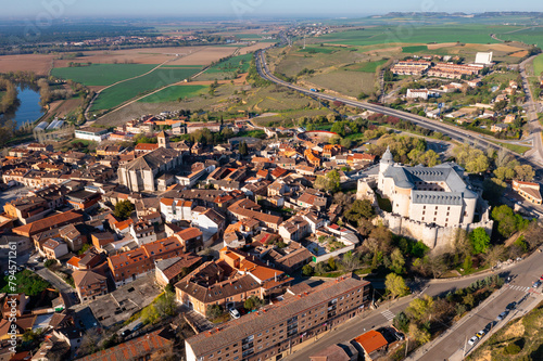 Aerial view of Spanish township of Simancas in province of Valladolid with Romanesque medieval church of El Salvador and walled fortified castle surrounded by residential buildings  photo