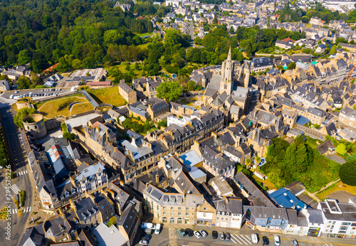 Scenic drone view of summer cityscape of Guingamp with Gothic Basilica of Notre Dame de Bon Secours and medieval castle walls, France