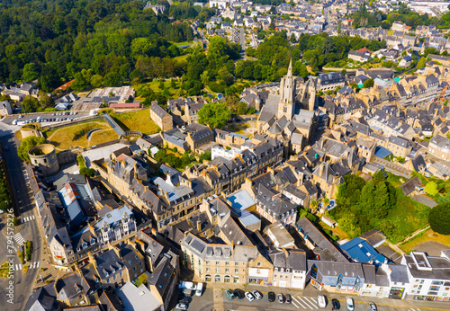 Scenic drone view of summer cityscape of Guingamp with Gothic Basilica of Notre Dame de Bon Secours and medieval castle walls, France photo