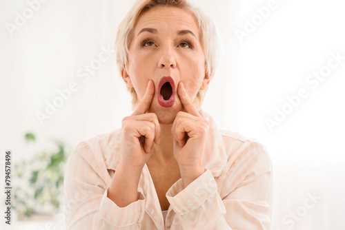 Mature woman doing face bui...