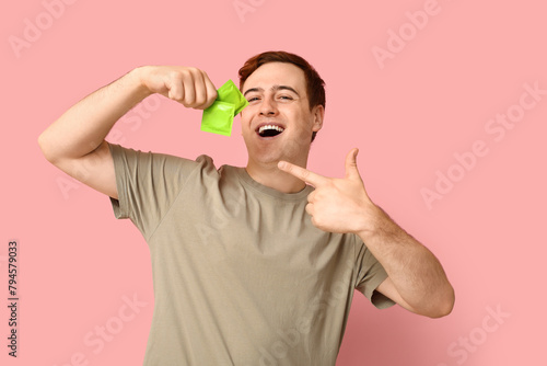 Happy young man pointing at...