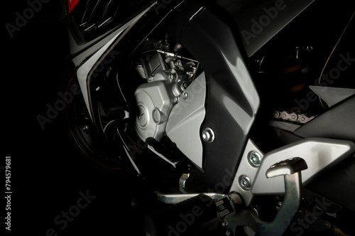 engine side of black sports type motorbike with fuel injection system photo