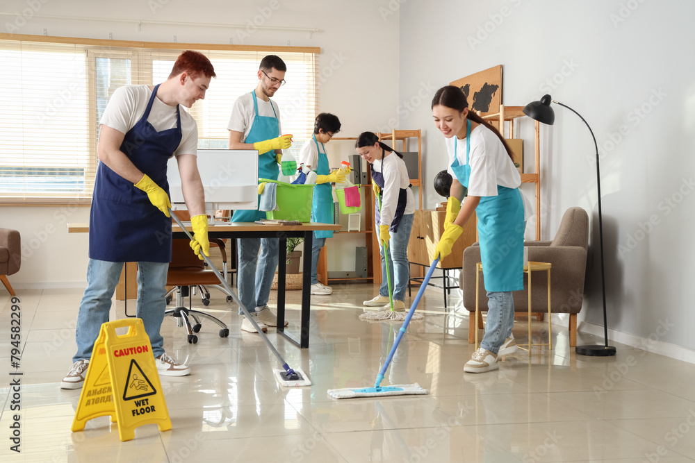 © Pixel-Shot - Young janitors cleaning in office
