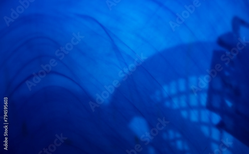 abstract blue background with some smooth lines in it and some reflections