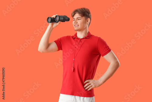 Male lifeguard with binocul...