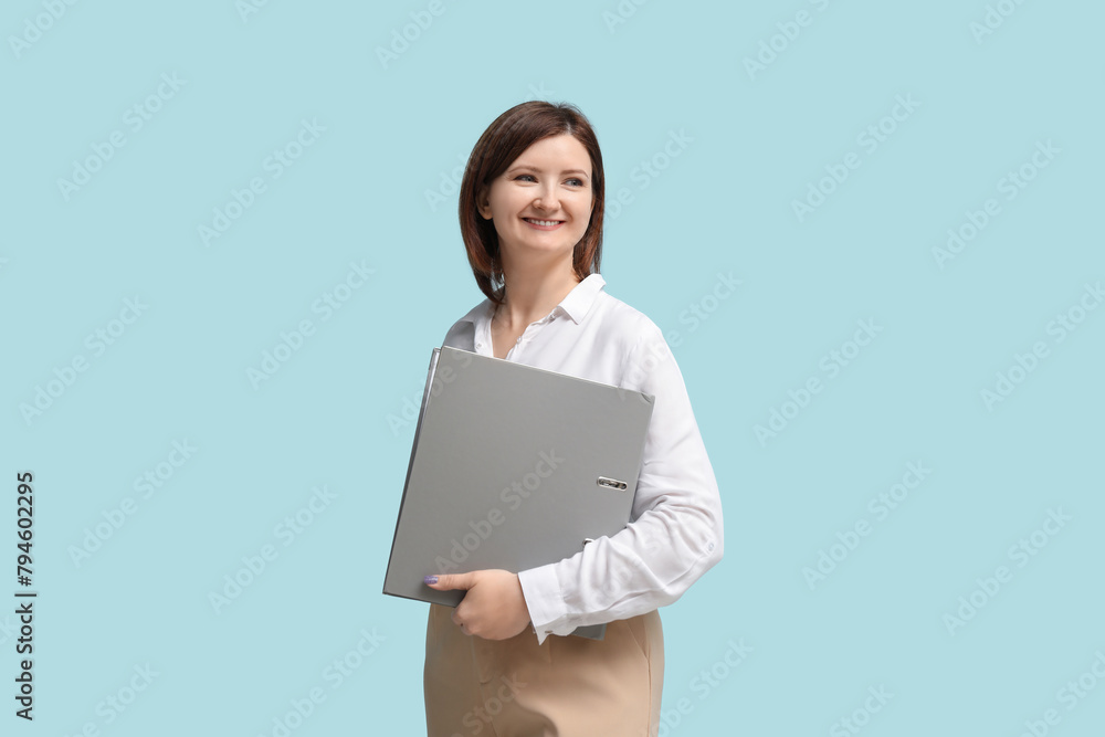 Young pretty businesswoman with office folder on blue background Young pretty businesswoman with office folder on blue background