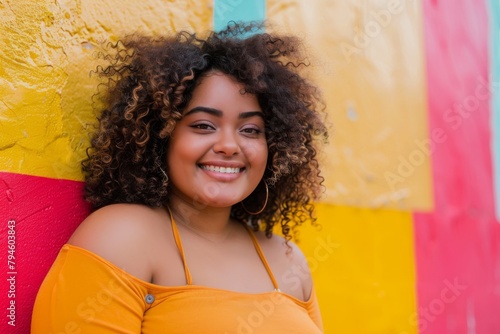 Smiling plus size woman against a colorful wall