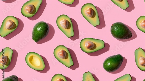 Close-up avocados pink background