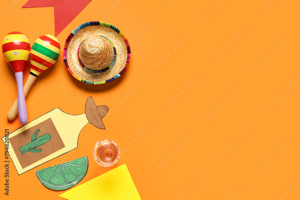 Obraz premium Mexican maracas with sombrero, tequila and decor on orange background. Cinco de Mayo