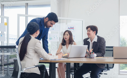 Portrait business team woman and man asian group meeting sit look holding document and look computer talking new project creative write note plan ready for happy working online sale inside room office © Singh
