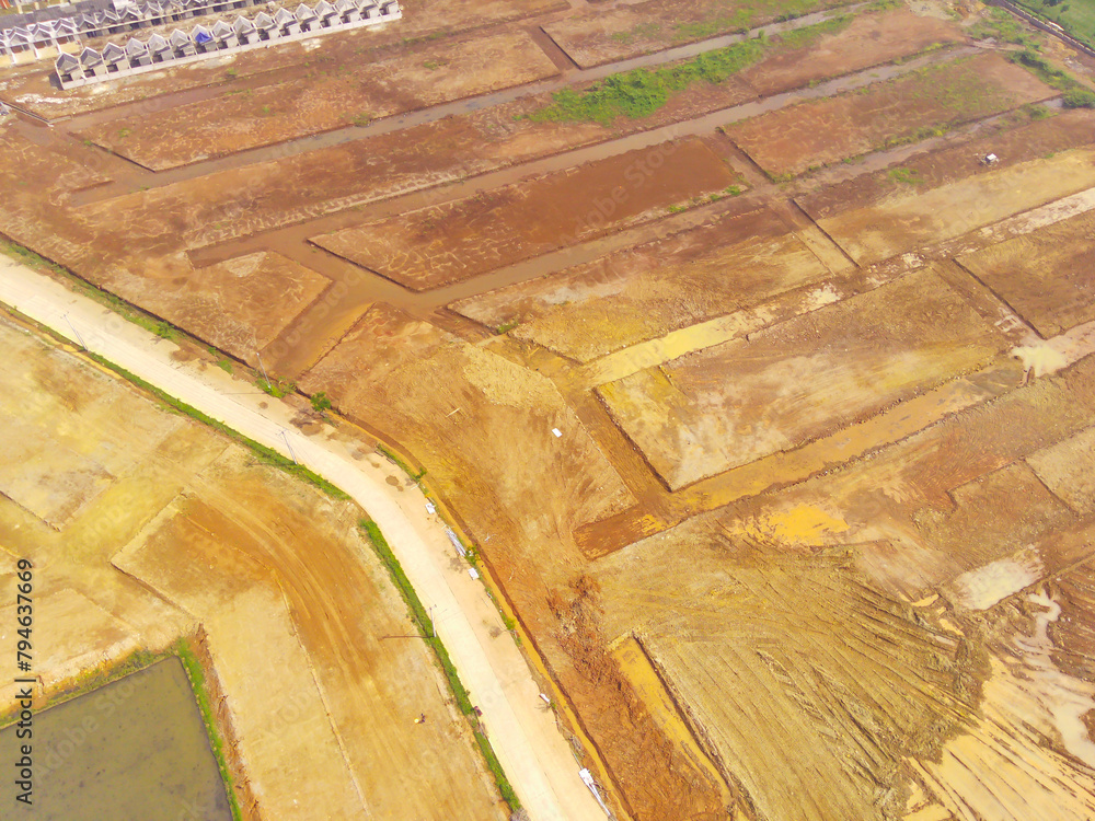 Land leveled for public houses. Aerial drone view of Housing development on the edge of the city. View from above, Housing Industry. Above. Social issues. Shot from drone flying 100 meters