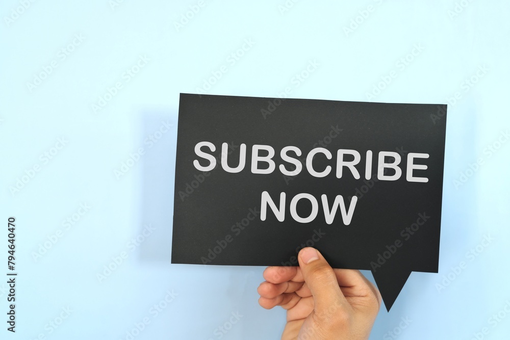 Human hand holding speech bubble with written word Subscribe Now. Human hand holding speech bubble with written word Subscribe Now.