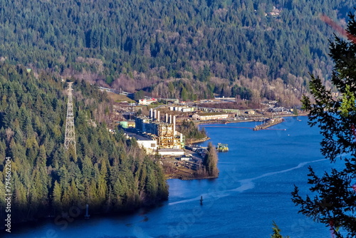 View at Burrard Generating Station from Burnaby Mountain Park. The station is located on the banks of the Burrard Inlet at the foot of a wooded slope