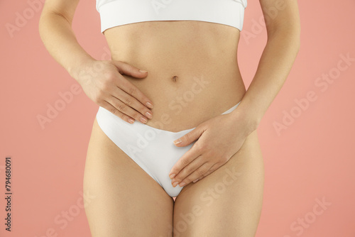 Gynecology. Woman in underwear on pink background, closeup