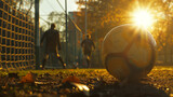 Soccer ball resting in net sunset