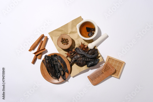 Flat lay herbs and wooden tools on minimalist background with the main composition is black locust fruits. Photo for design banner or poster of products made from locust © Tuan  Nguyen 